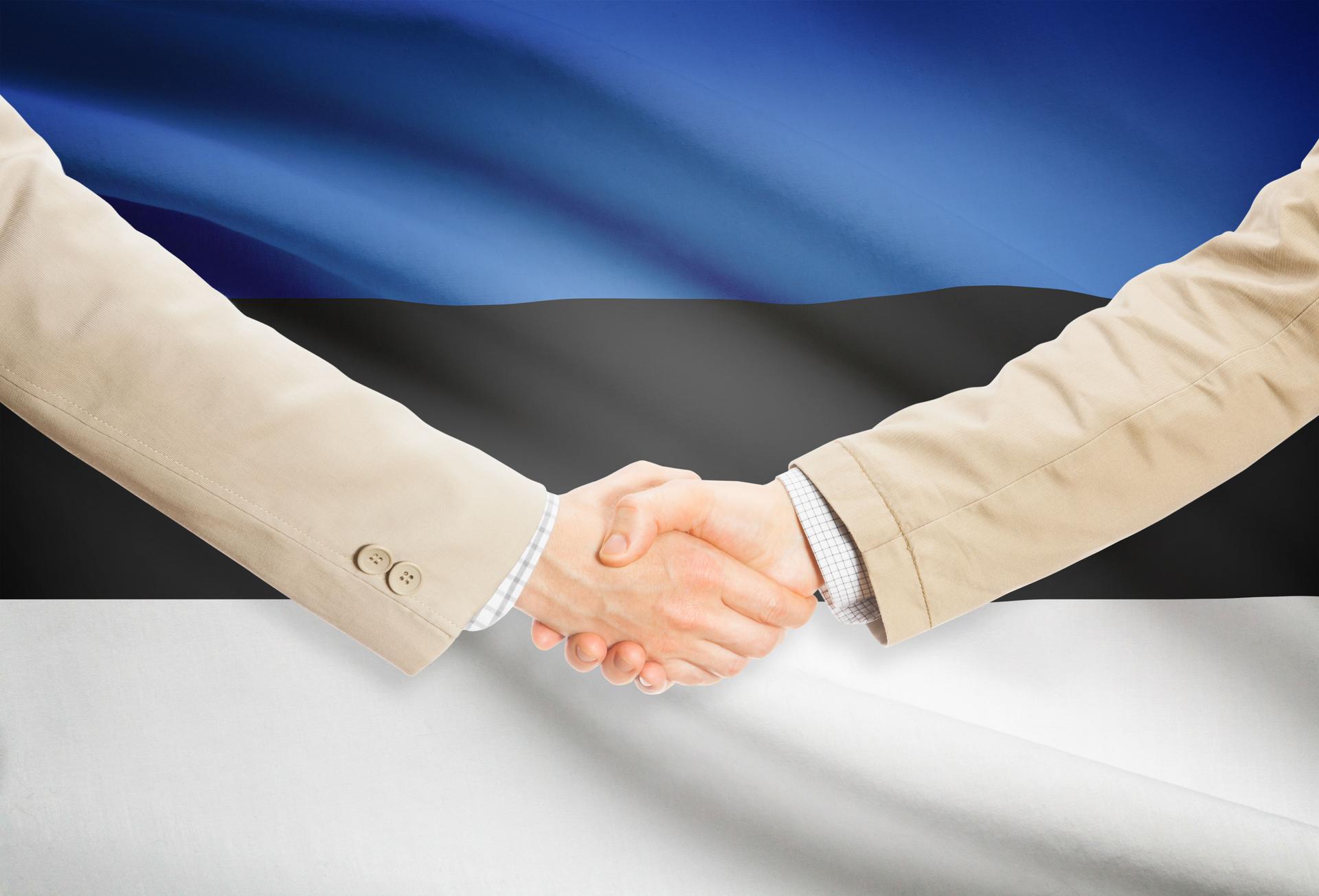 Businessmen handshake with flag on background - Estonia