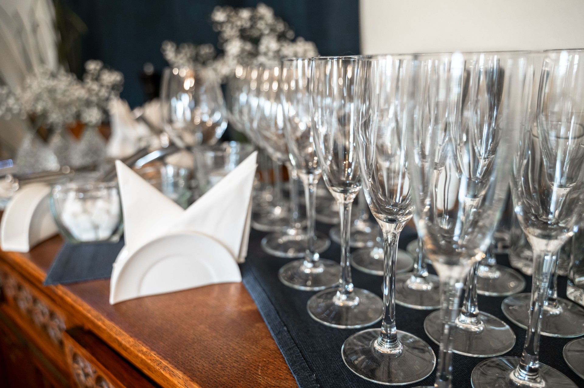 Glasses and other tableware arranged for use by waitstaff